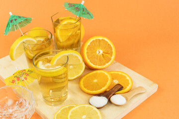 Glasses of cold tea with slices of orange and lemon