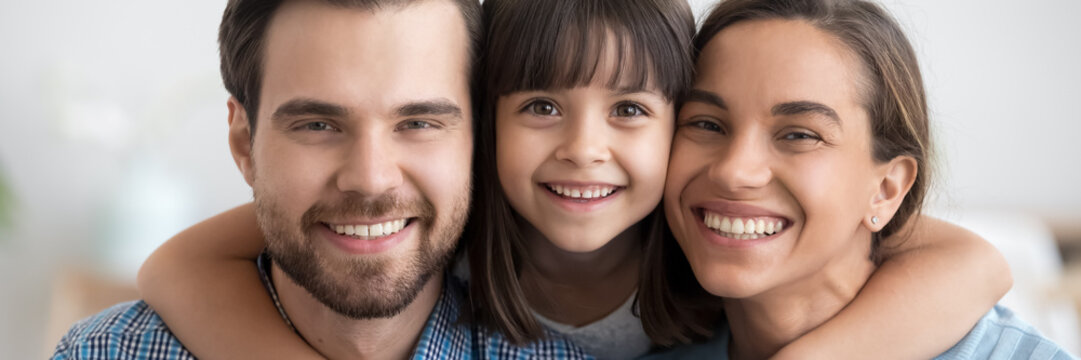 Beautiful little daughter cuddles loving mother caring father cheerful parents close up, people making picture together. Happy family portrait concept horizontal photo banner for website header design