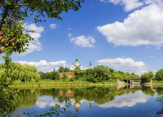 Fototapeta na wymiar Medieval Discalced Carmelites monastery over river, general view, Berdychiv, Ukraine