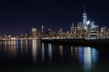 Fototapeta na wymiar NEW YORK CITY, USA - december 25, 2017 skyline with reflection in cold winter night lake