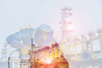 Double exposure of Welding in Industry worker at the factory welding on Oil Tanker for ship Repair on structure oil refinery plant background.