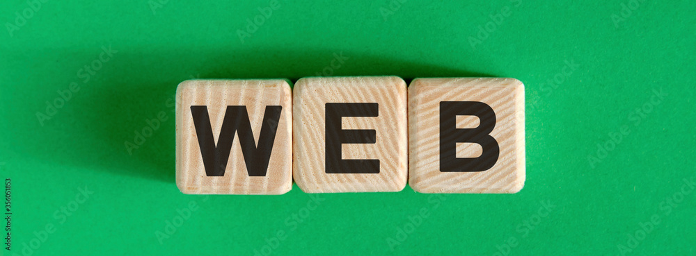 Poster WEB website - text on wooden cubes with green background