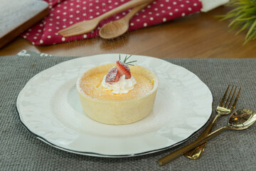 Homemade cheesecake with fresh strawberry on white plate