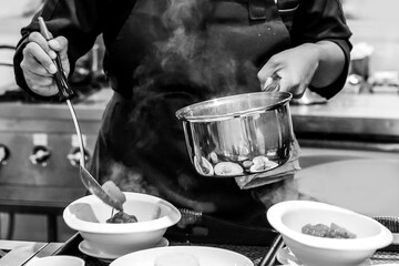 Chef cooking in a kitchen, chef at work, Black & White.