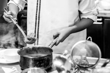 Chef cooking in a kitchen, chef at work, Black & White.