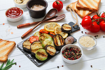 Healthy vegetarian grilled table with bbq gluten free bread and vegetables (zucchini, eggplant, carrot, lemon)