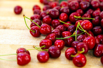 Ripe sweet cherries on a wooden background.