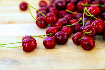 Ripe sweet cherries on a wooden background.