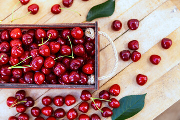 Ripe sweet cherries on a wooden background.