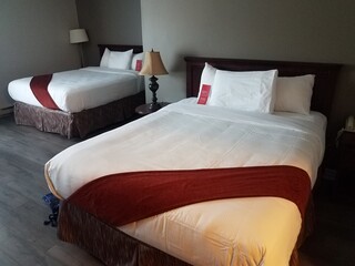 red and white blanket and sheets in hotel room