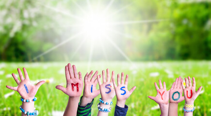 Children Hands Building Colorful Word I Miss You. Green Grass Meadow As Background