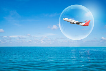 Fototapeta na wymiar Travel bubble concept - Airplane traveling in bubble representing international travel bubble project to revive tourism and hotel industry among countries that show good control of covid 19 spreading.