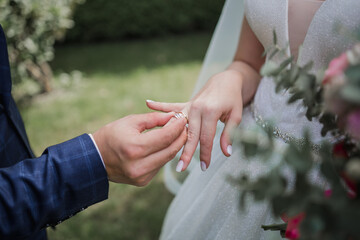 the bridegroom puts a ring on the bride’s finger
