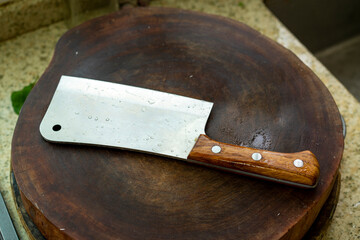 A kitchen knife on a cutting board in the kitchen