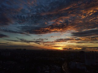 Early morning in Bangkok Thailand with cloudy blue sky sunbeam and building shadow