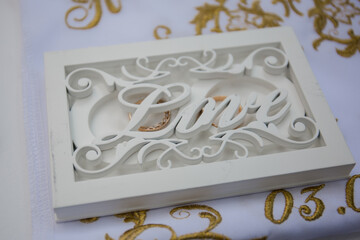 wedding rings in a box with the inscription love