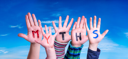 Kids Hands Holding Colorful English Word Myths. Blue Sky As Background