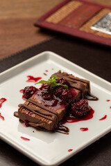 chocolate terrine cake piece with raspberry syrup