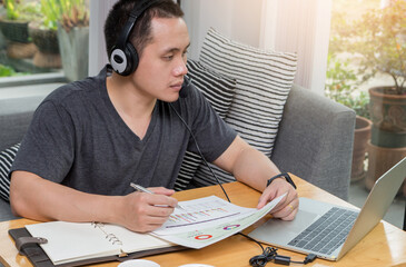 A young businessman sitting at a computer desk, Work from home and social concept.