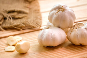 Garlic bulb head and cloves on wooden floor, Herbs and spices are important in cooking