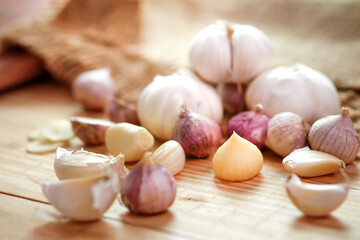 Garlic bulb head and cloves on wooden floor, Herbs and spices are important in cooking