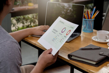 A young businessman sitting at a computer desk, Work from home and social concept.