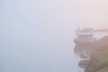 Boat parked and morning fog along the Mekong River in Chiang Khan District, Loei Province