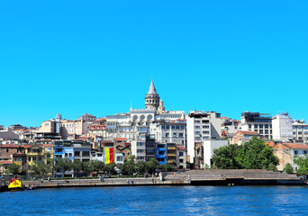 Fototapeta na wymiar View from water on Galata Tower and Beyoglu district, Istanbul, Turkey