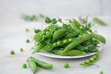 fresh green peas with greens and pea pods