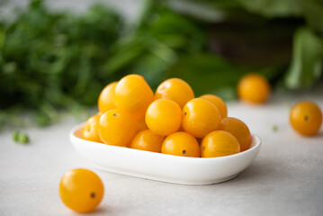 small yellow cherry tomatoes with herbs