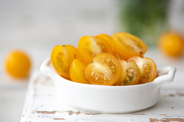 small yellow cherry tomatoes with herbs
