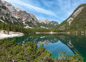 Naklejka na ściany i meble panoramic view of iconic mount Seekofel mirroring in the clear calm water of Pragser Wildsee (Lago di Braies) in Dolomites, Unesco World Heritage, South Tyrol, Italy
