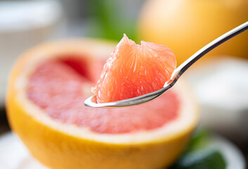 juicy grapefruit pulp on a teaspoon
