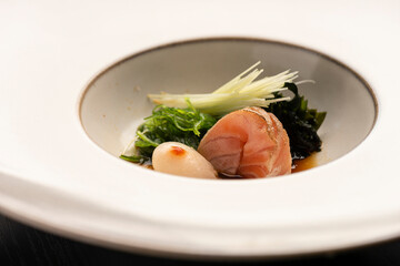 sashimi japanese dish with vegetables on white ceramic
