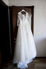 wedding dress hanging on the closet in the room