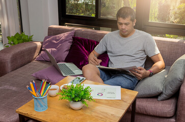 A young businessman sitting at a computer desk, Work from home and social concept.