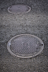 Sewer manhole on a city road.