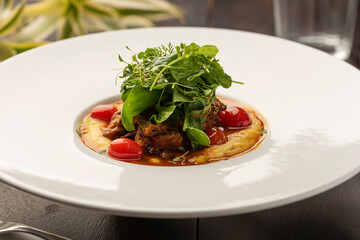 creamy polenta made with corn flour with confit tomatoes and salad