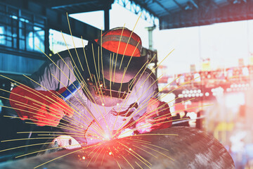 Welder is Welding Metal steel pipe in factory with sparks light wearing protective mask industrials...