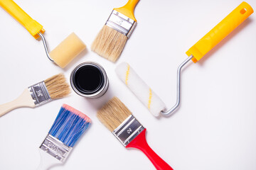 Tin can with paint and lot of different decorator brushes