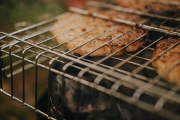 The process of preparing meat cutlets for grilled burgers. Picnic in the fresh air. High quality photo