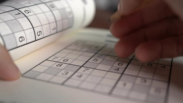 Writing on Sudoku puzzle with pencil