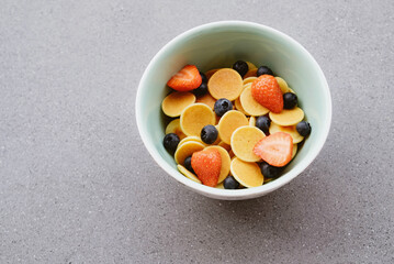 Freshly cooked pancake cereal in a bowl served with fresh berries.