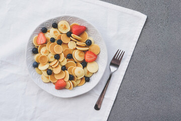 Freshly cooked pancake cereal served with fresh berries, top view.