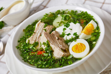 Healthy green sorrel soup with eggs and pork ribs