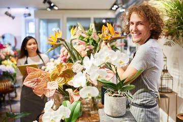 Young florist with assortment of colorful flowers