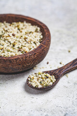 Peeled hemp seeds in a wooden bowl. Hemp - superfood, antioxidant, healthy supplement.