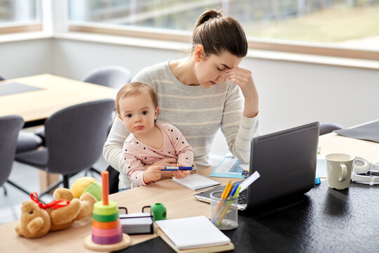 remote job, multi-tasking and family concept - tired mother with baby working at home office