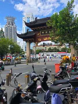 morning street in china busy with people on motorbikes and tourists