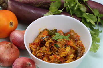 Baigan Bharta or Vangyache Bharit, a roasted and mashed eggplant fry or curry, favourite maharashtrian curry, served in a bowl, Indian traditional food